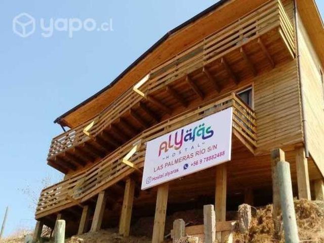 Hostal con camas, closet y mobiliario cocina