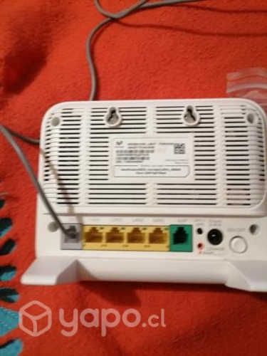 Un router con todos sus accesorios y su caja.